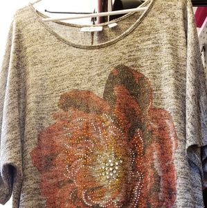 Sparkly Gray  Blouse with a flower on the front.